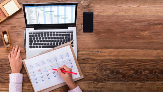 New CISO creates schedule plan on a calendar and on a laptop