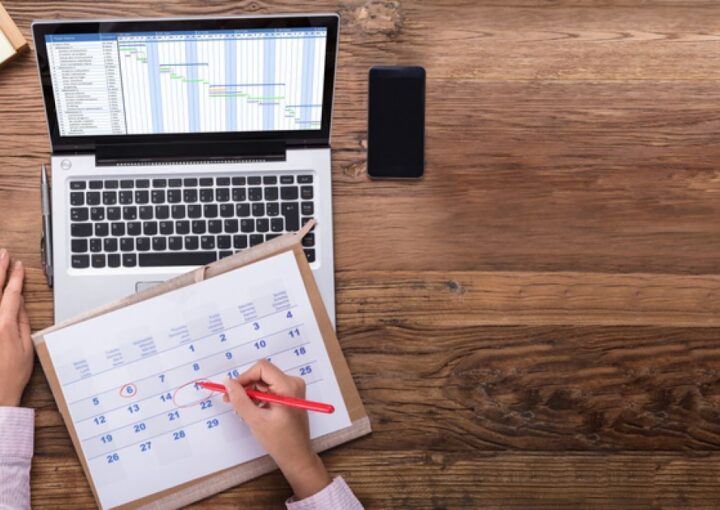 New CISO creates schedule plan on a calendar and on a laptop
